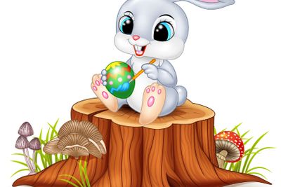 Cartoon Easter Bunny painting an egg on tree stump