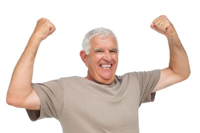 Portrait of a cheerful senior man with clenched fists