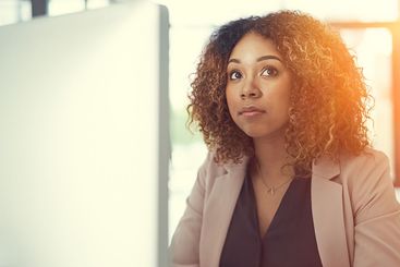 Thinking, computer and planning with business woman in...