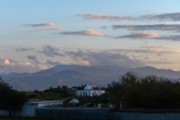 Majestic mountain view at dusk with clouds casting...