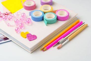 Colorful crafting supplies arranged on a workspace...