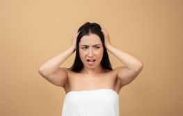 Young woman displaying frustration while caring for her...