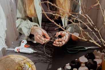 Female hands making egg shell handmade decoration for...