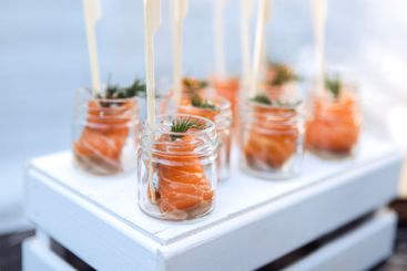 Small glass jars with pieces of red salted fish