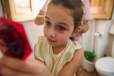 Young child gazes inquisitively at vibrant decorative...
