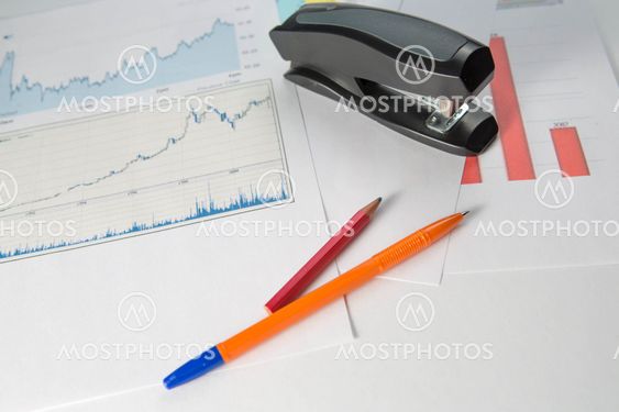 Business background with pen, pencil and stapler