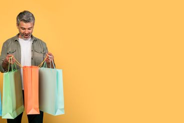 Shopaholics. Overjoyed middle aged caucasian couple...