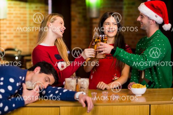 Smiling friends with christmas accessory