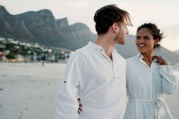 Vacation, travel and interracial couple embrace at ocean...
