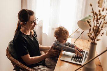 Woman working at home with her baby