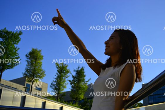 Beautiful young asian woman pointing
