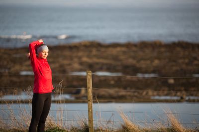 Young woman on her evening jog along the seacoast