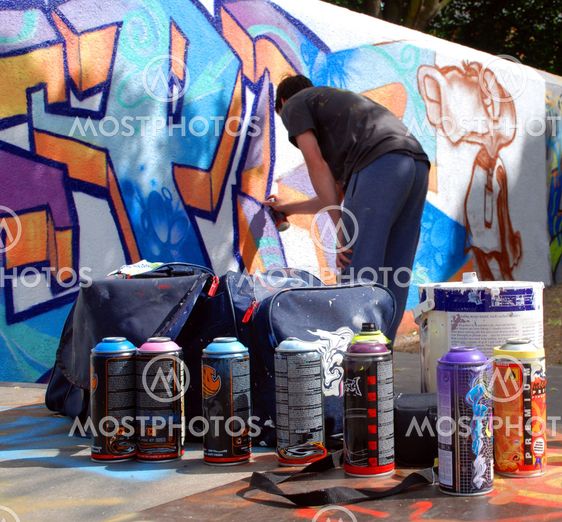 Graffiti artist at work with tools