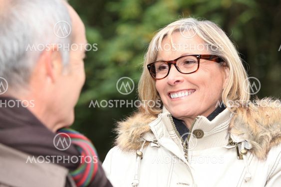 A middle age couple in a park.