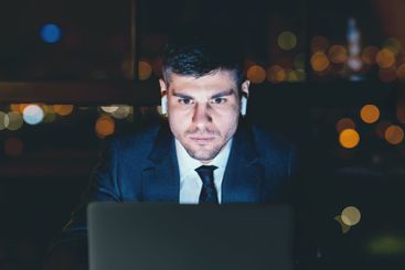 Concentrated Business Guy At Laptop Working Wearing...