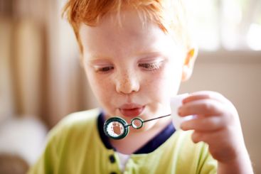 House, blowing bubbles and boy with fun, game and...