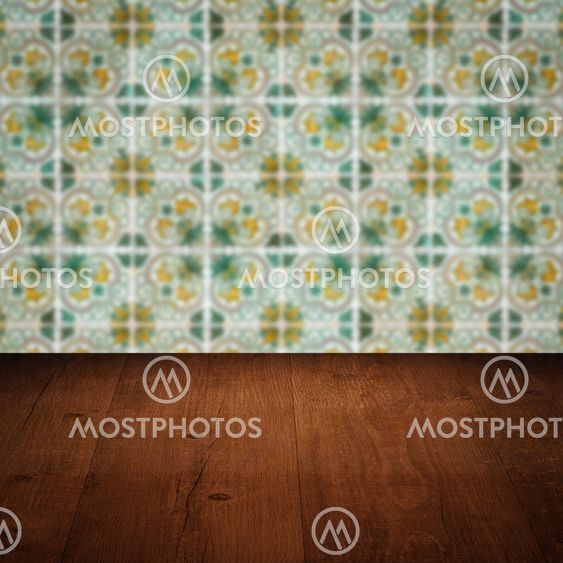 Wood table top and blur vintage ceramic tile pattern wall