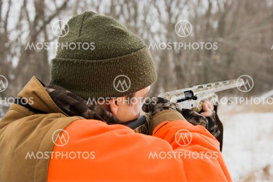 Man aiming shotgun.