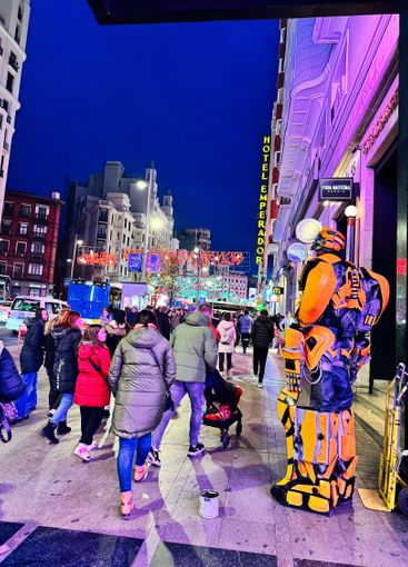 Evening street view with a lively crowd and colorful...