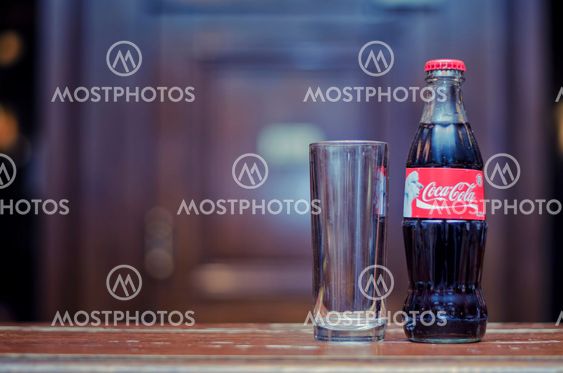 Coca cola in bottle with glass
