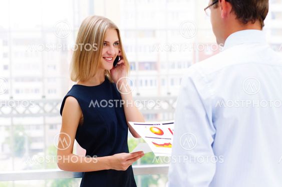 business man and business woman discuss reports
