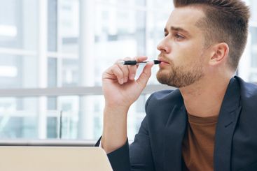 Thinking, idea and business man with pen in office for...