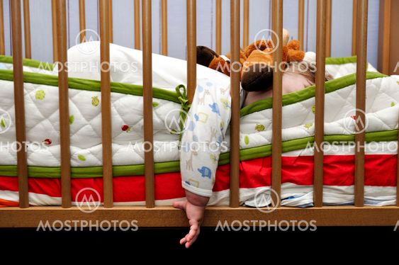 Baby sleeps put out hand for bed