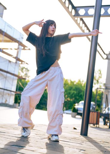 Dancer showcases urban choreography in sunlight near...