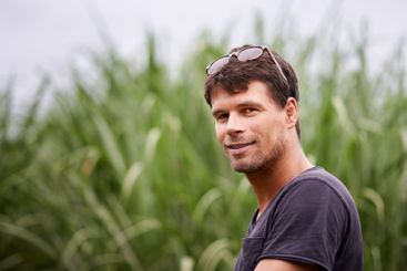 Sustainable farming, smile and portrait of man in corn...