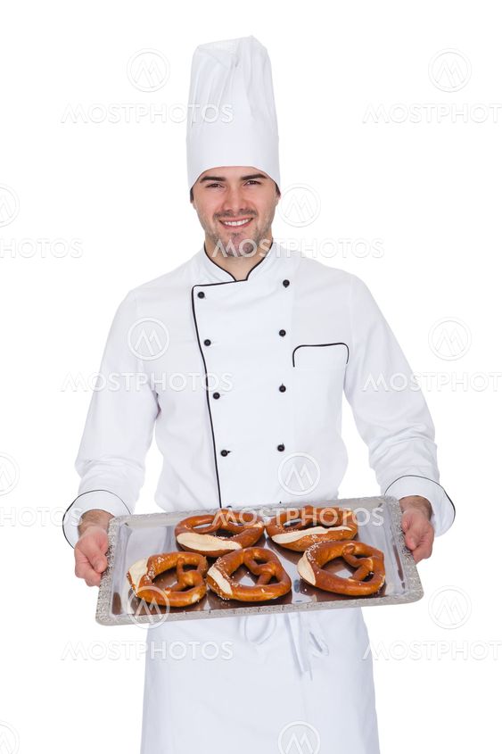 Portrait of happy bakerman with tray