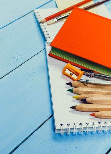 Collection of colorful stationery items arranged on a...