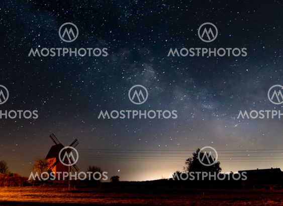 milky way over windmill in the night