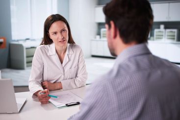 Consultation between male physician and female patient