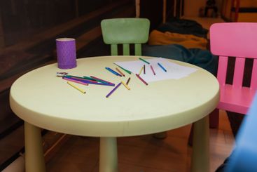 Childhood concept. Colored pencils and a blank sheet of...