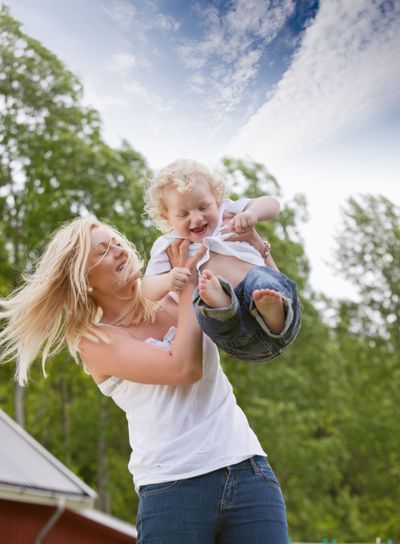 Woman playing with little child