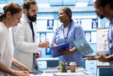 Skilled team of experts review x ray scans and discuss...