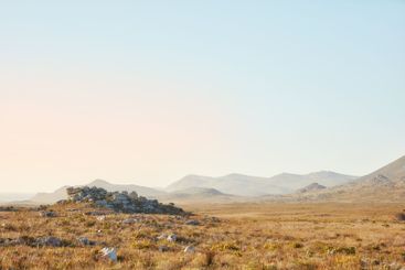 Wilderness, sky and rocks with field landscape for...
