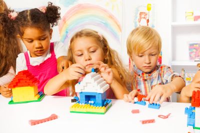 Group of kids playing with plastic blocks