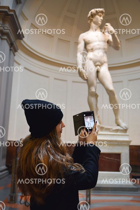 girl take photos David by Michelangelo in Galleria dell Accademia, Florence