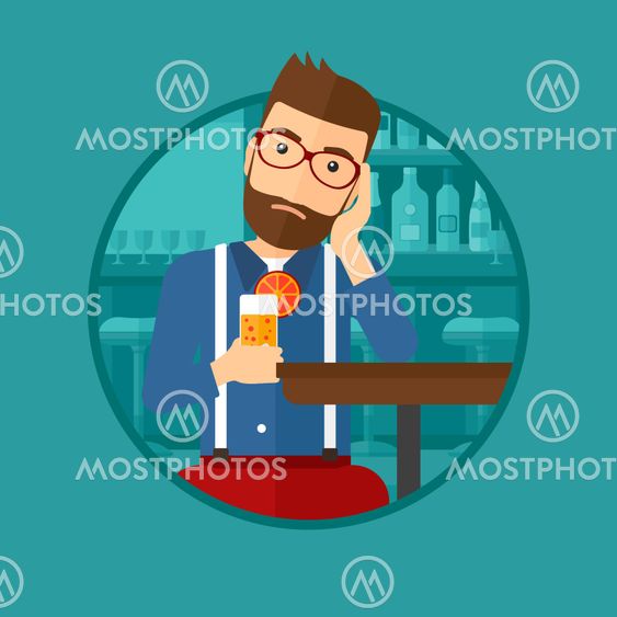 Man drinking orange cocktail at the bar.