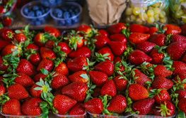 Fresh ripe strawberry in plastic boxes on farmers market...
