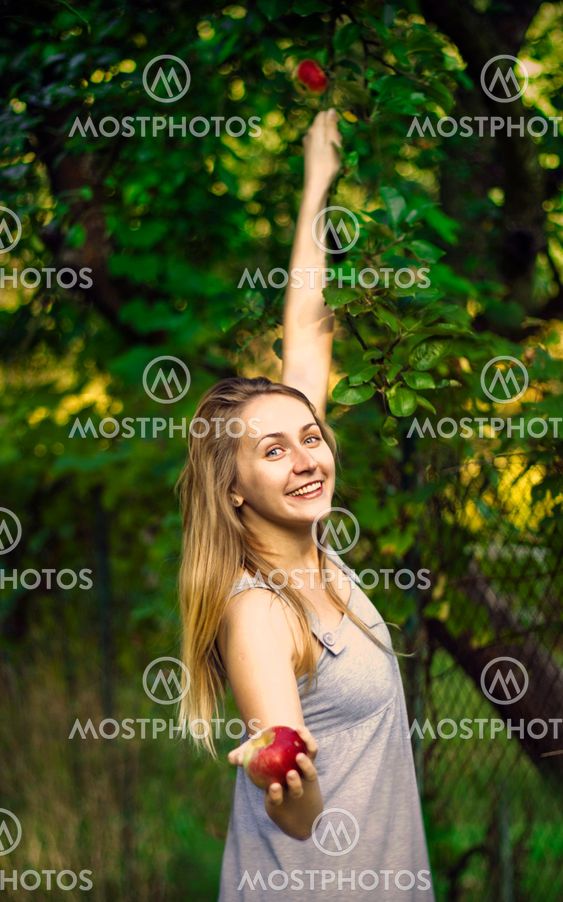 Blond young woman in a garden