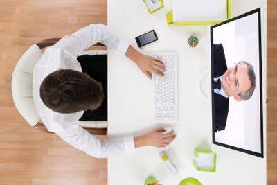 Businessman Videochatting With Senior Staff