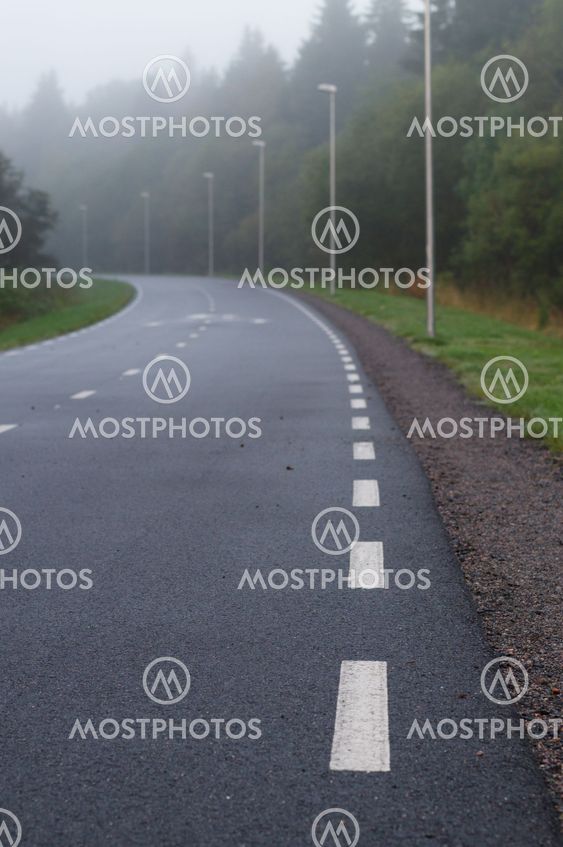 Winding walkway and cycle path on foggy morning