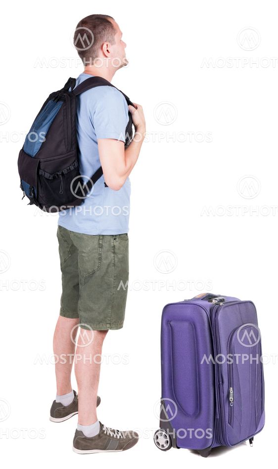 Back view of young man traveling with suitcas.