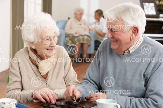 Couple Playing Dominoes At Day Care Centre