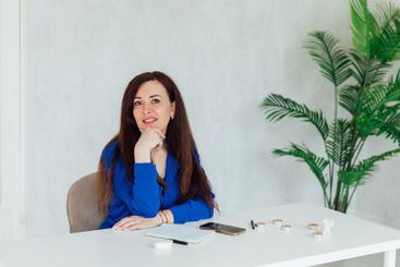 Brunette businesswoman sitting at desk in office