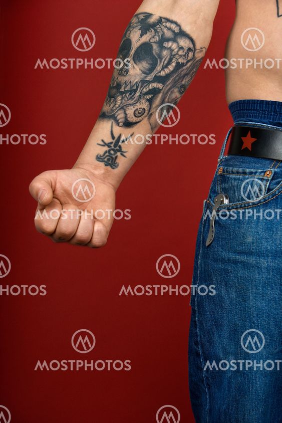 Adult male arm with tattoo.