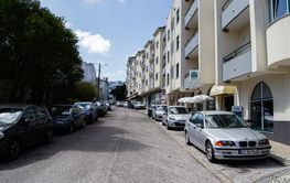Street in Fatima Portugal with parked cars and...
