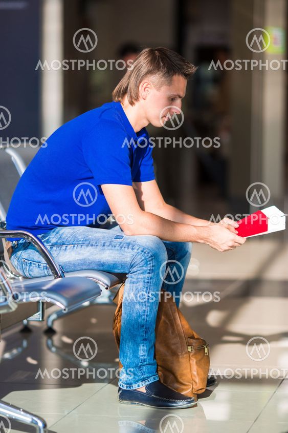 Young manwith passports and boarding pass at airport...